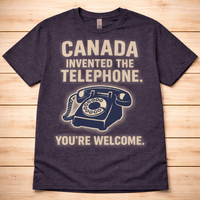 Navy blue t-shirt with vintage telephone graphic and text on a wooden surface